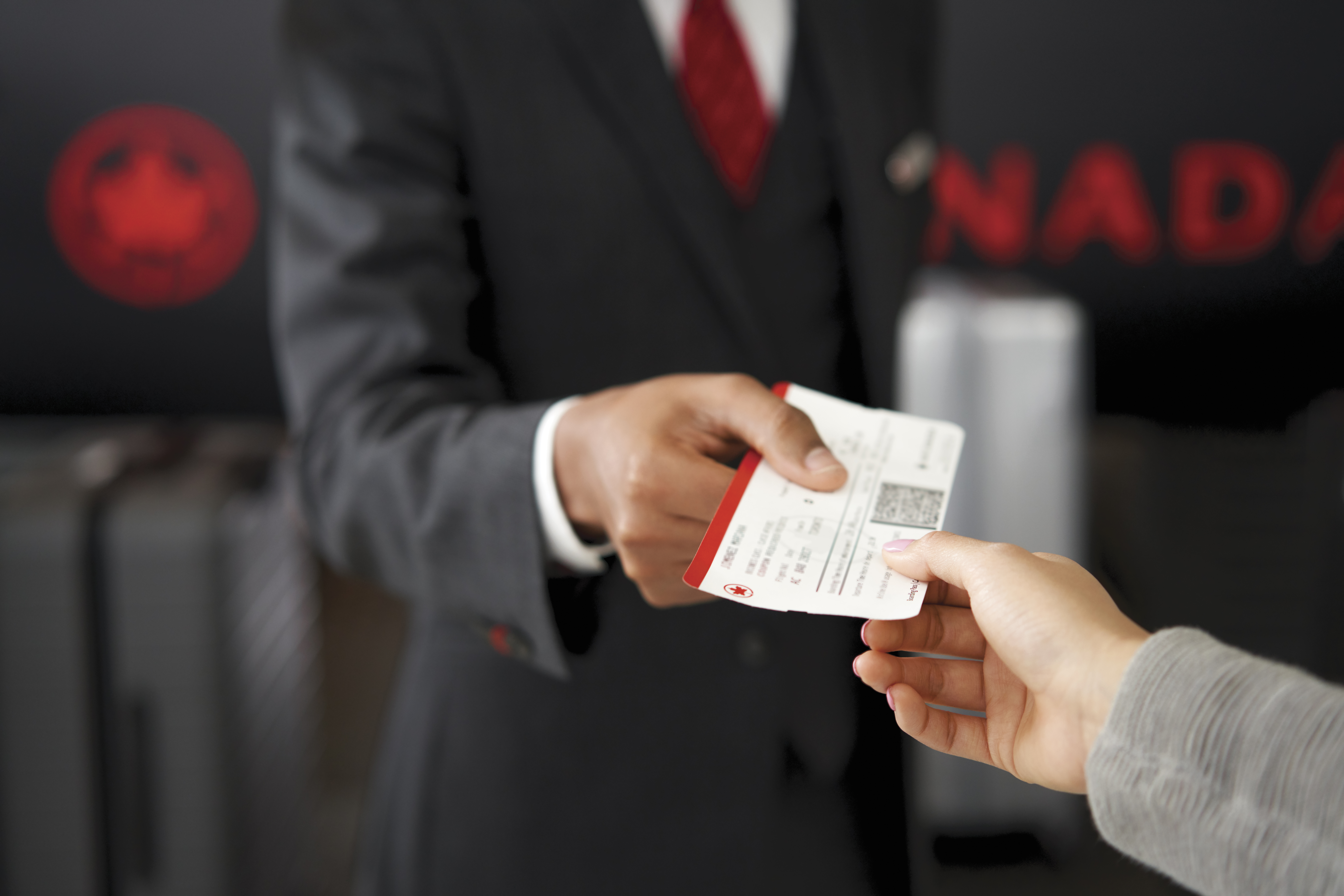 <p>Airport agent taking boarding pass at gate</p>
